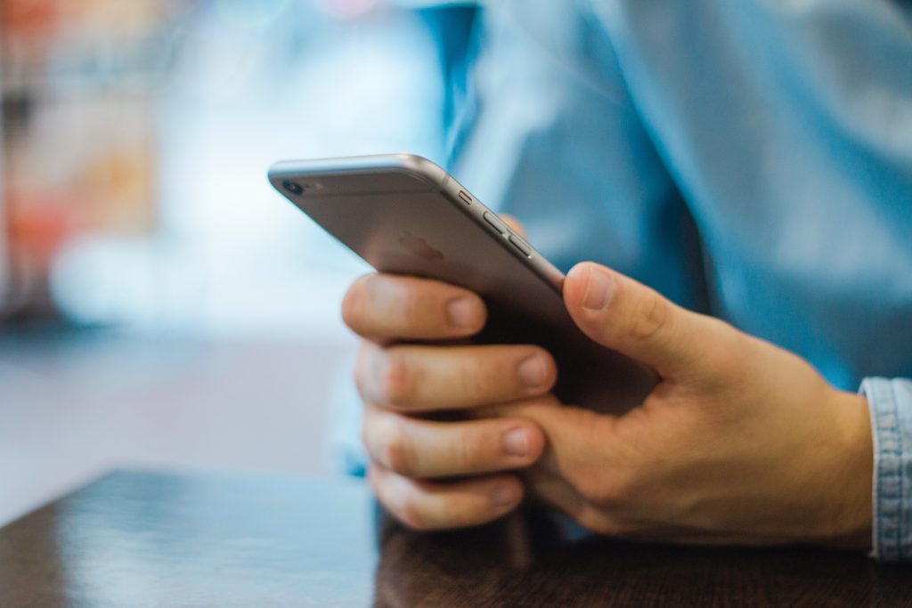 Close-up image of a person's hands holding a smartphone